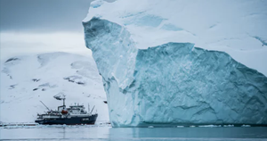 ship in front of an iceberg